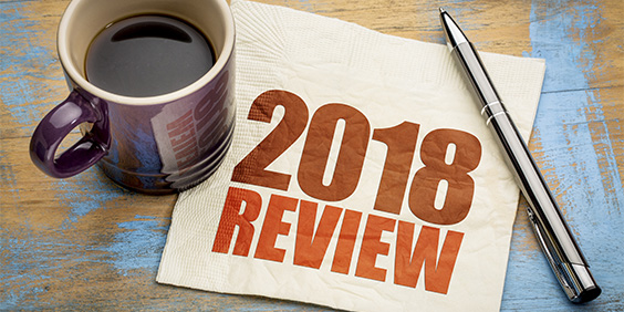 2018 review text on a napkin with a cup of coffee